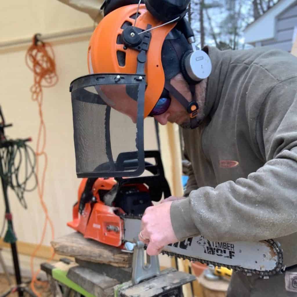 man sharpening his chainsaw