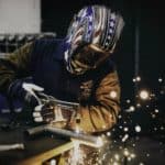 person wearing multi-colored welding helmet