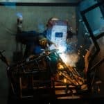 man-in-black-jacket-and-helmet-holding-a-mig-welder