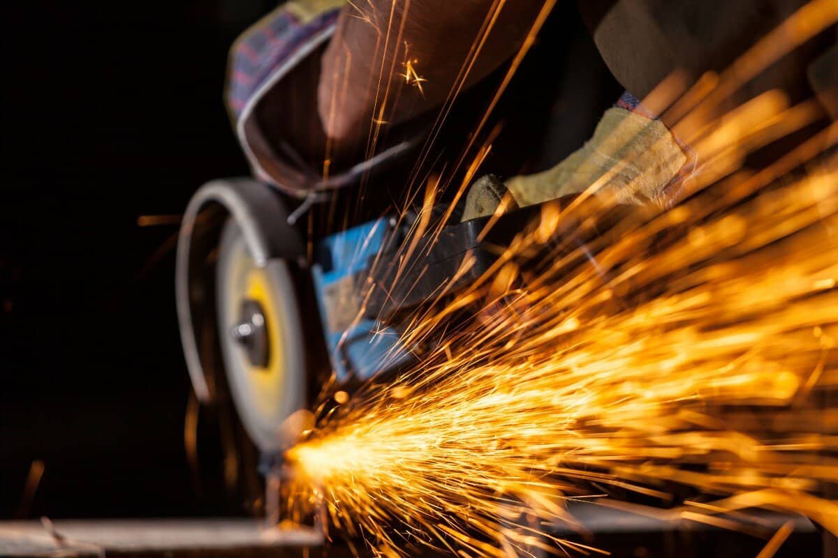 Man Cutting Metal With Angle Grinder