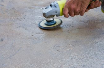 Man Grinds Concrete With Angle Grinder